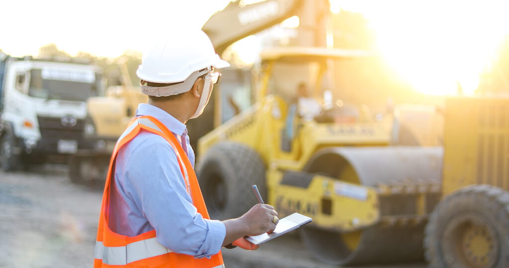 A person is checking heavy machinery for their business case.