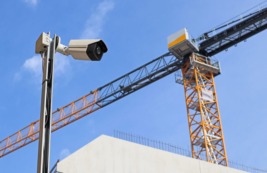 Construction Site Theft Prevention: Security camera at the construction site with a tower crane
